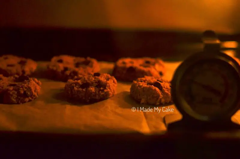 banana oatmeal chocolate chip cookies baking in the oven with an oven thermometer