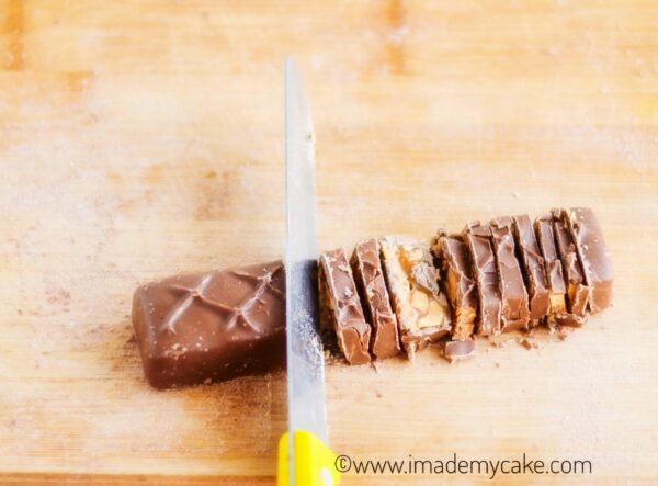 chopping snickers bar for making snickers chocolate fudge