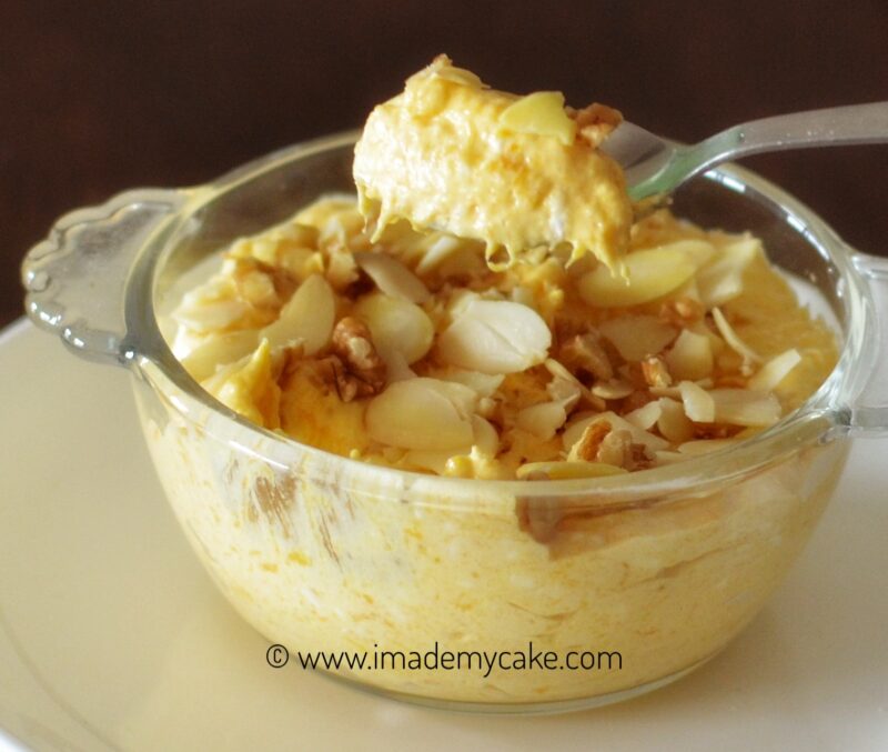 bowl of mango cream topped with chopped mangoes